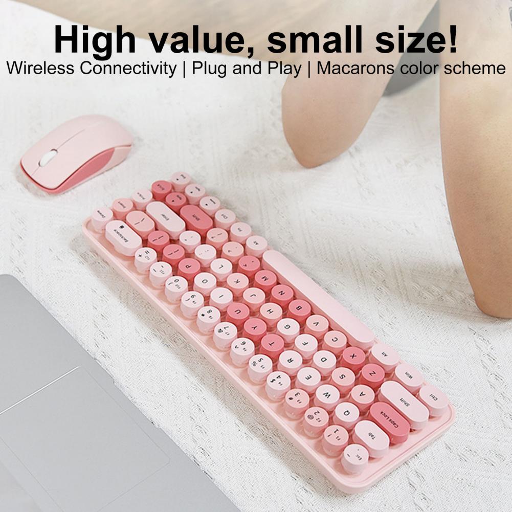 Pink keyboard with matching mouse near an open laptop
