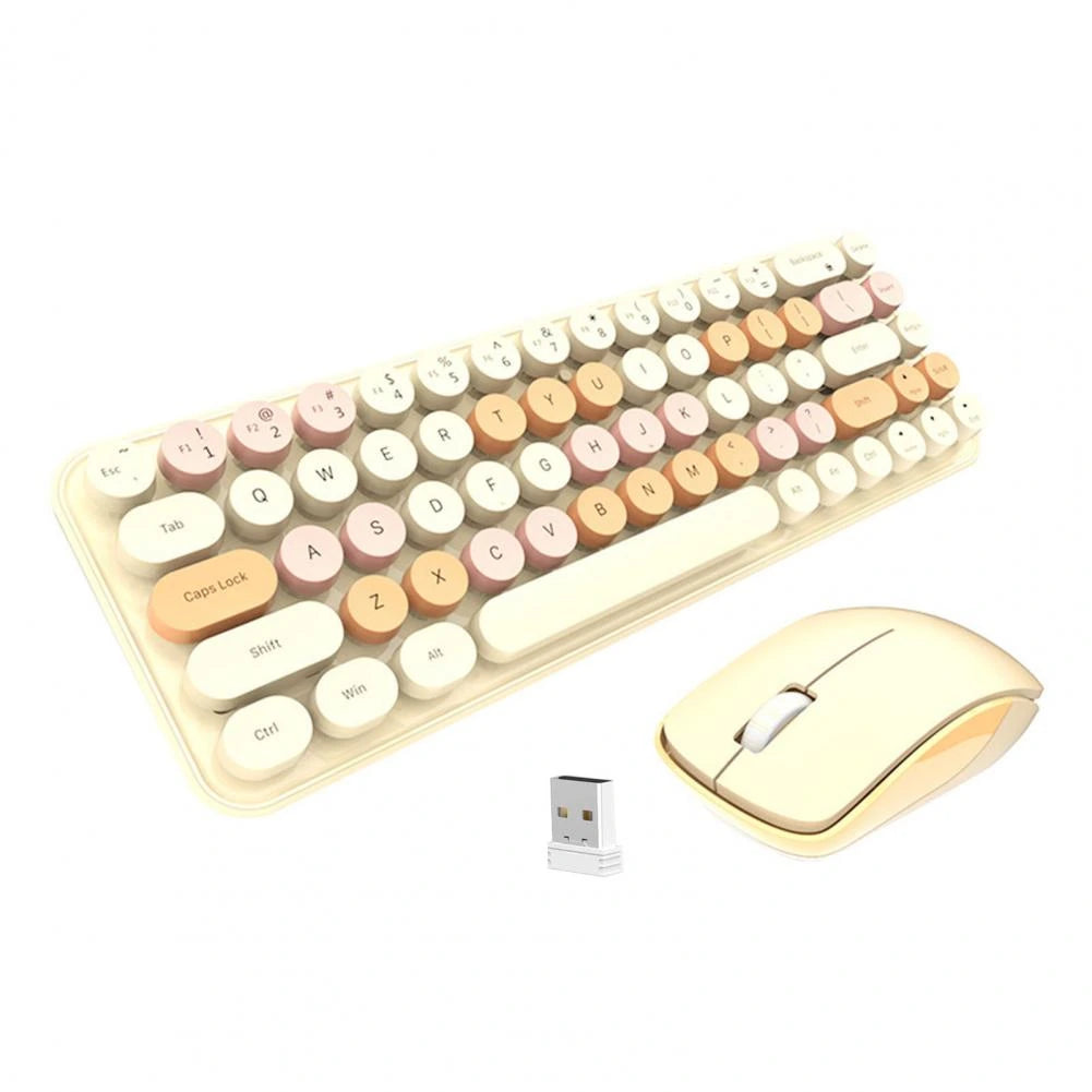Wireless keyboard and mouse in pink with a laptop nearby