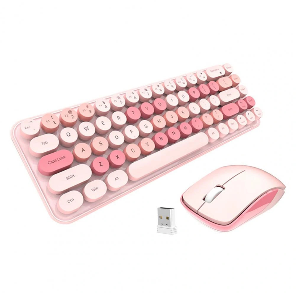 Cream wireless keyboard and mouse on a desk with a laptop